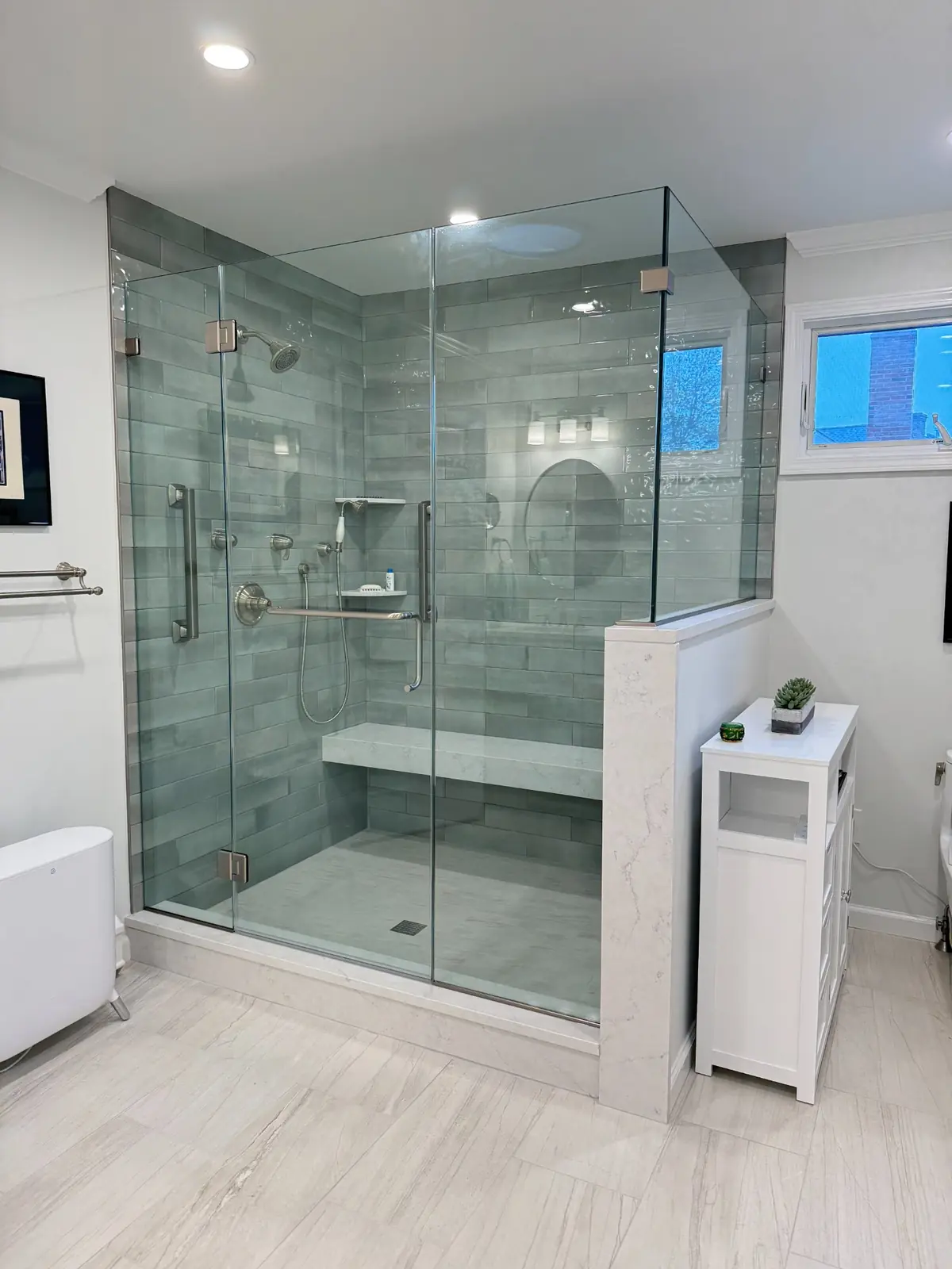 Tiled walk-in shower with a built-in bench and green wall tile